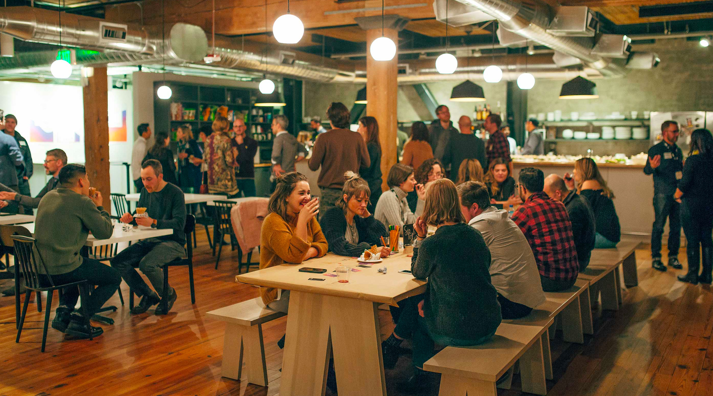 Visitors and designers mingle, chat, drink, and color together at Artefact's Interaction 19 studio party.