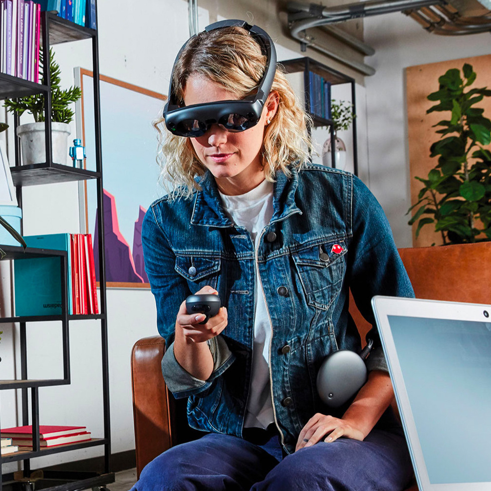 Blonde woman wearing the Magic Leap One headset sitting in an office.